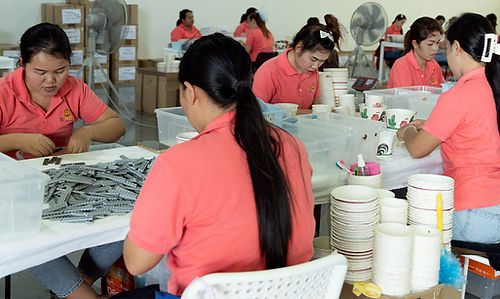 professional workers sorting and packaging lego pieces in warehouse