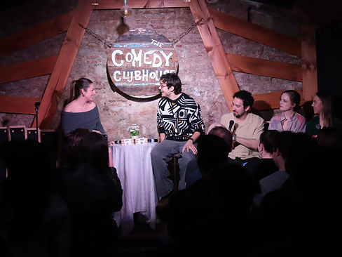 Live comedy date with a man and a women on stage laughing at a Lolyamorous show in Barcelona.. Photo by Olga Camacho