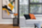 Modern living room with gray sofa, abstract art
