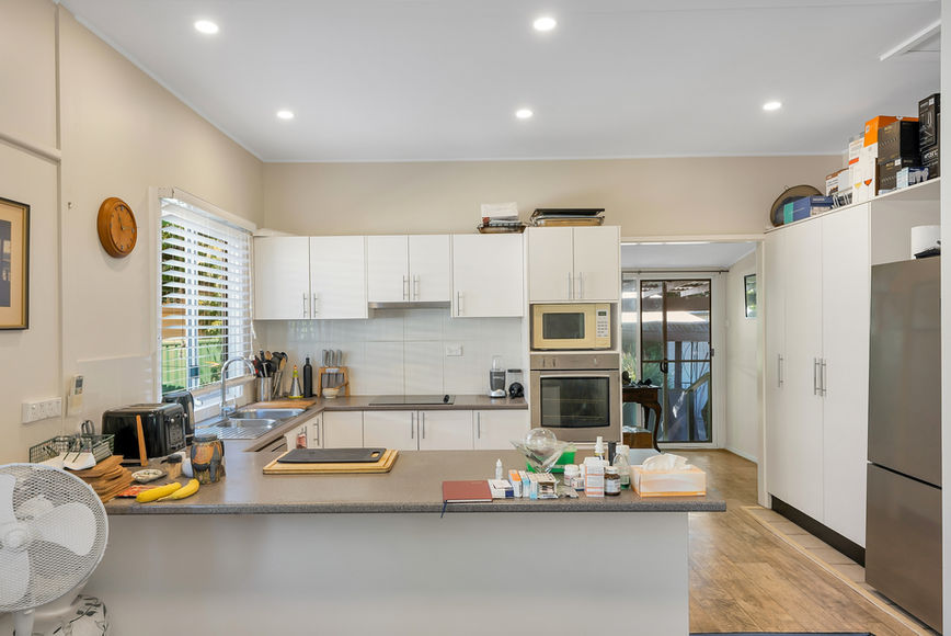 Bright modern kitchen with white cabinets and light countertops