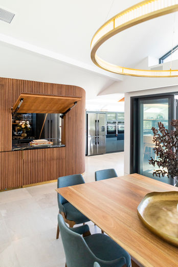 Modern dining room with wood table and hidden kitchen area