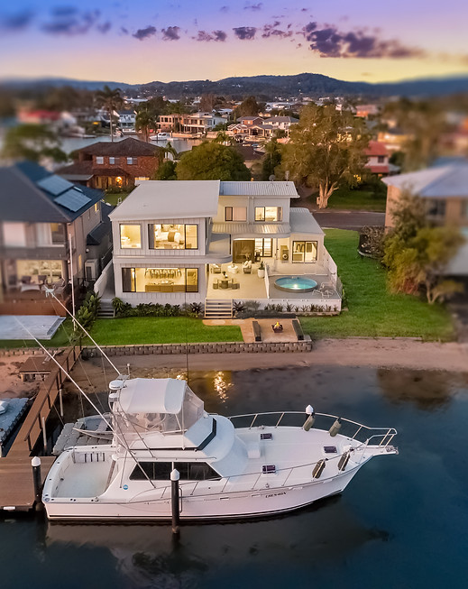 Waterfront house with a white boat docked at a pier