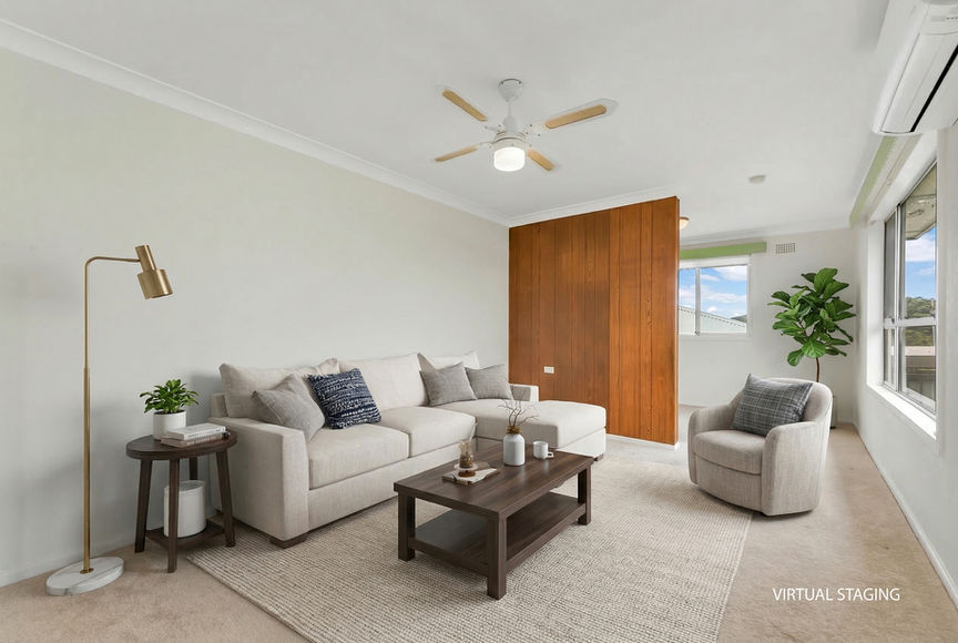 Virtually staged living room with sofa, coffee table, and armchair.