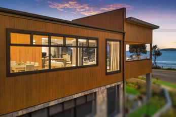 Modern house by the ocean at sunset