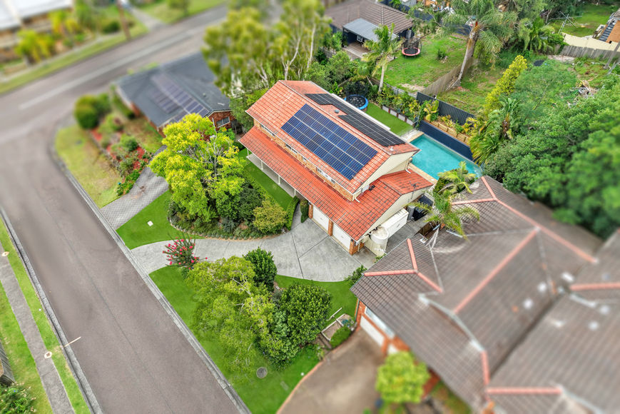 House with solar panels and pool from above