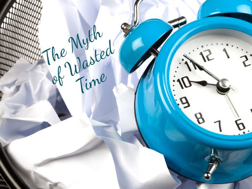 Blue alarm clock on crumpled paper in a wastebasket with text The Myth of Wasted Time