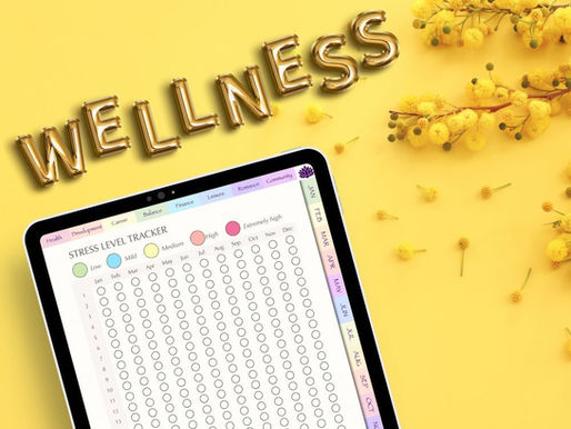 Tablet with stress level tracker on yellow background with "WELLNESS" in gold letters and yellow flowers nearby. Calm and organized mood.