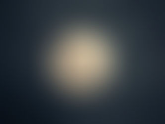 Full moon glowing in a dimly lit cloudy night sky, creating a serene and calm atmosphere.