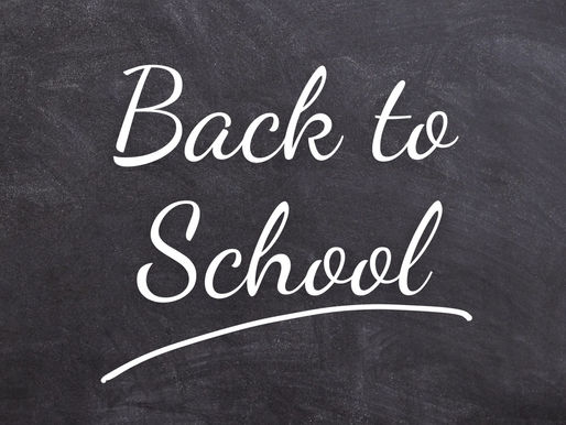 Back to School text in white on a black chalkboard background, conveying a sense of education and new beginnings.
