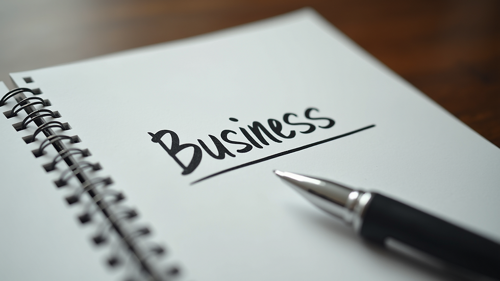 Close-up view of a notebook with business goals and a pen