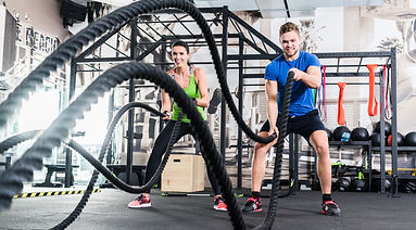 Men with battle rope in functional train