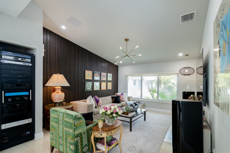Moody living space with plush seating, layered lighting, and dramatic finishes by a Miami interior designer