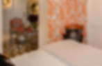 Eclectic guest bedroom with patterned orange wallpaper by Miami Interior Designer Mint Decor