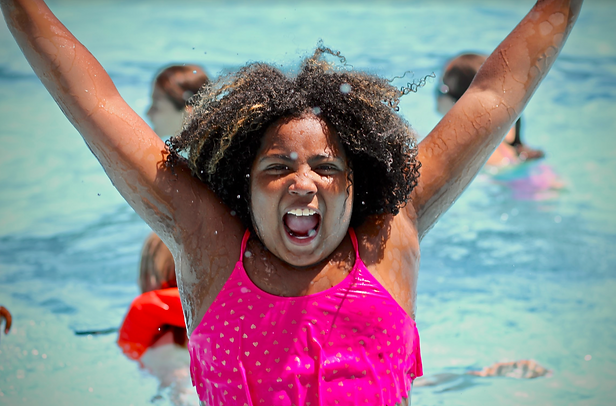 Girl shouting joyfully in pool