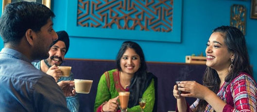 People bonding over Chai, their conversation filled with laughter and togetherness.