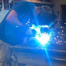 Josh under a welding hood