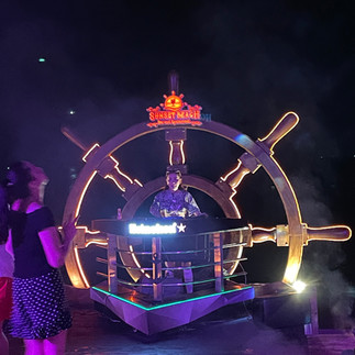 DJ performing under colorful lights at Sunset Beach Club in Phu Quoc at night.