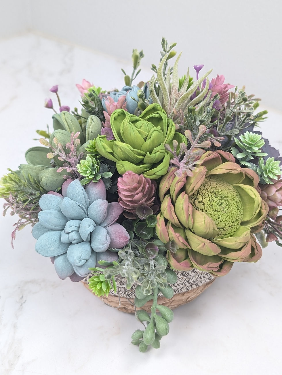 Thumbnail: Round bowl filled with wooden succulents