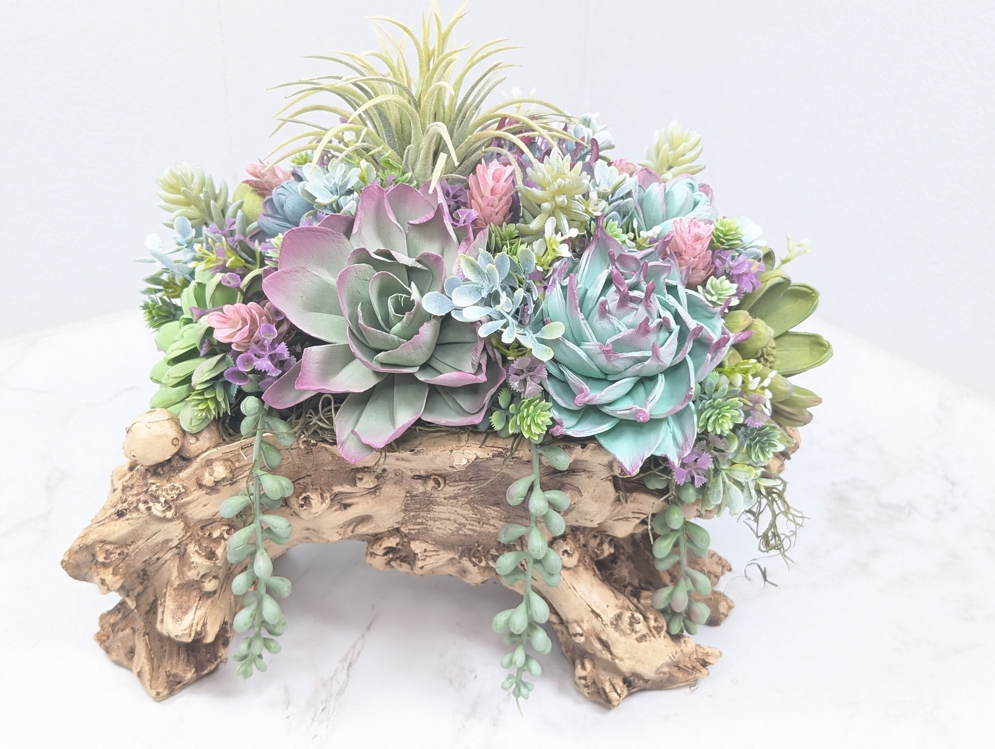 Faux log filled with wooden succulents