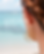 Woman wearing Lemurian Soul gold earrings bali by the ocean
