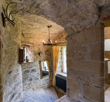 The top of a spiral staircase, the walls showing exposed stone 
