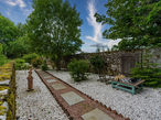 A formal garden with a statue and large chess set