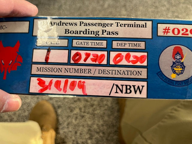 a picture of a laminated boarding pass to guantanamo bay