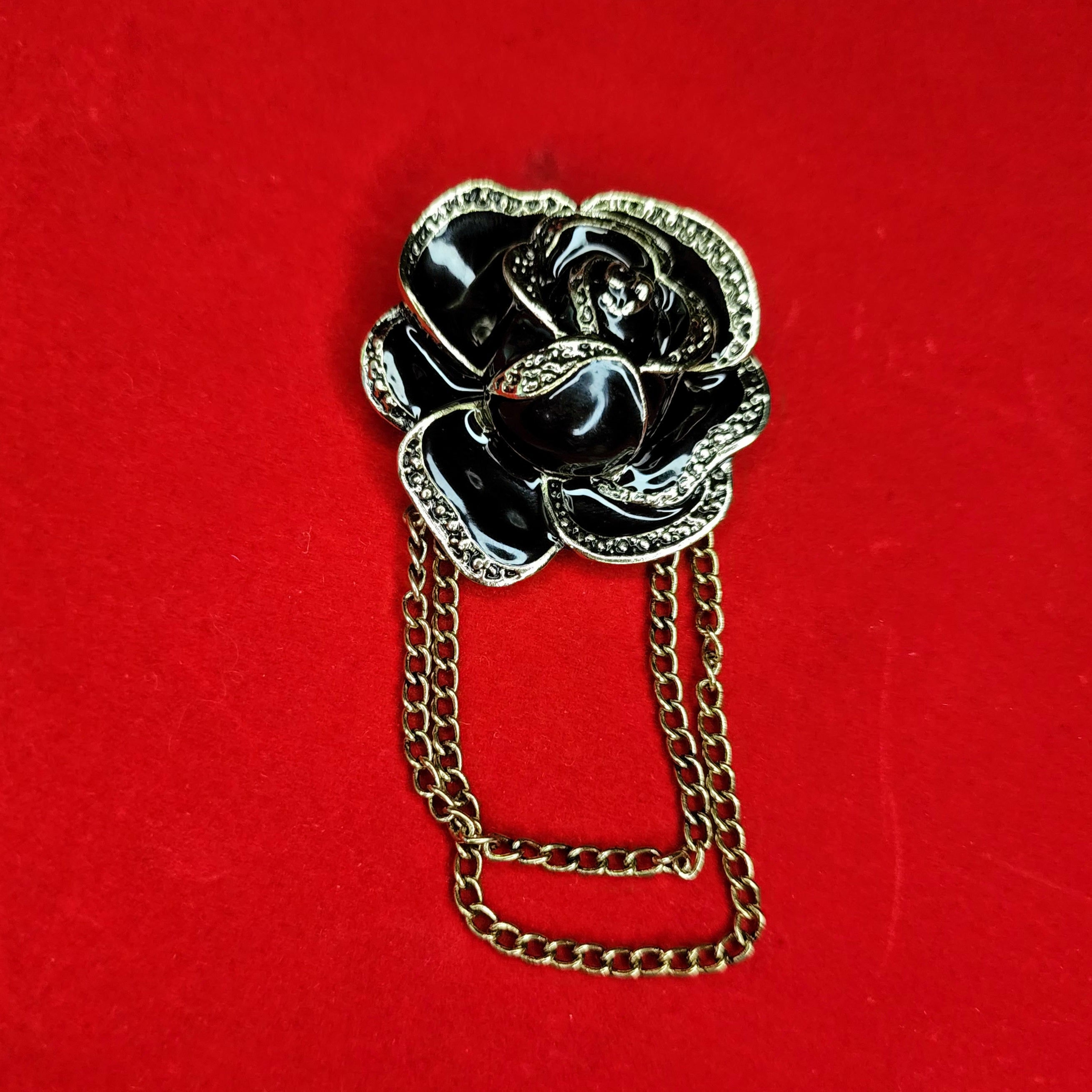 Elegant Gold and Black Flower Brooch with Chain Tassels