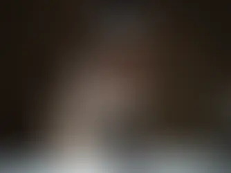 Woman in a black tank top reaching forward, symbolizing connection and engagement in a digital context.