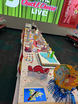 Birthday party table with Pokemon decor and cake