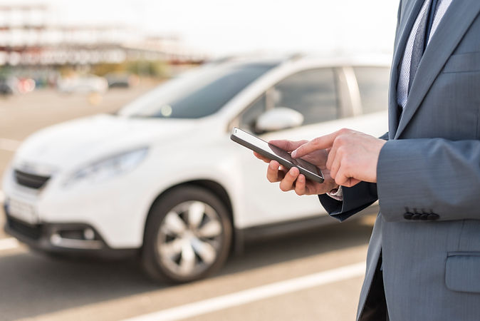 businessman-with-smartphone-front-car.jpg