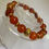 Thumbnail: Carnelian with gold focal bead, spacers & hearts - 8mm