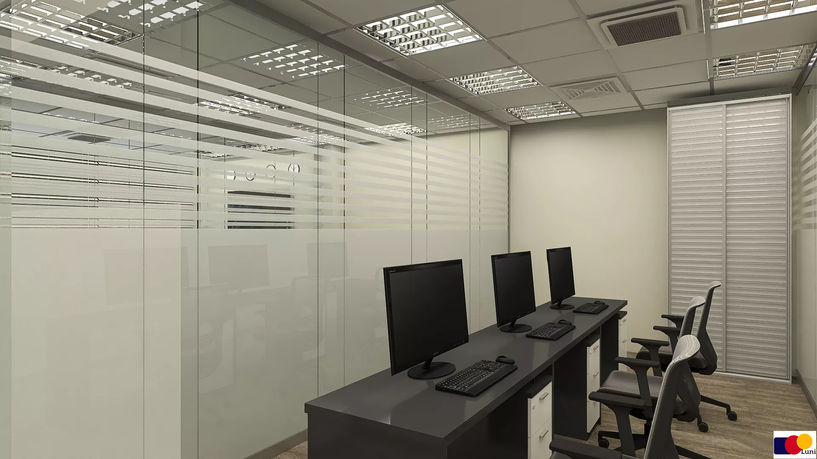 Modern office workspace with multiple workstations and glass partitions in Tbilisi