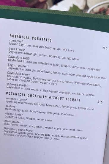 A menu featuring botanical cocktails and alcohol-free options, listing ingredients like seasonal berries, elderflower, and ginger.