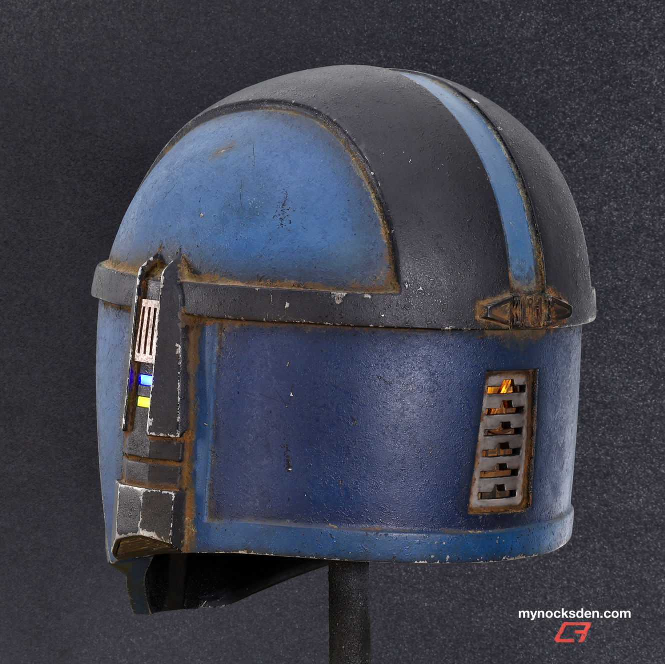 Mynock's Den fully finished, ready to wear Mandalorian Recon helmet with lights, rear-left view.