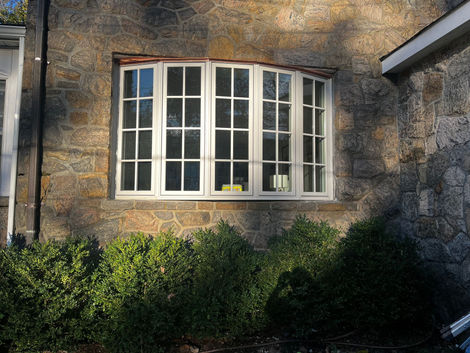 Bow window in stone.  Copper roof