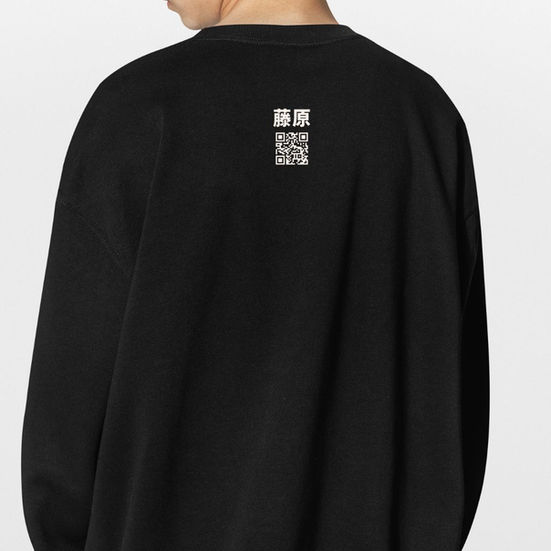 model wearing a black crewneck sweatshirt featuring a red and white traditional Japanese Kitsune fox mask graphic