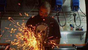 Welder creating bright sparks in industrial workshop – cinematic manufacturing footage by Caldwell Media