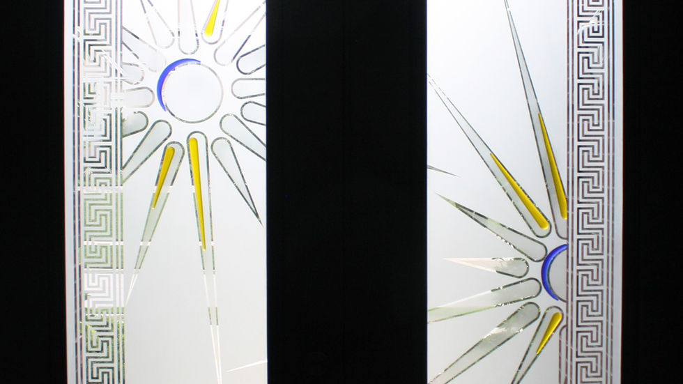Pair of etched glass double doors with Greek key borders, Sunburst symbols, and Celtic knots, accented with yellow and blue glass elements.