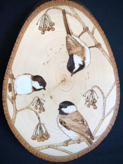 three chickadees on berry branches