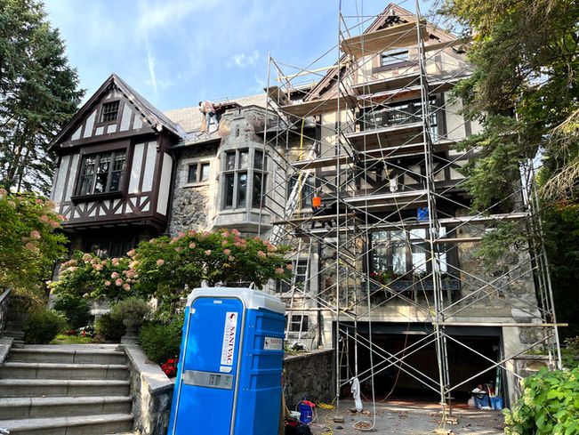 Exterior painting of stucco façades in Westmount using scaffolding