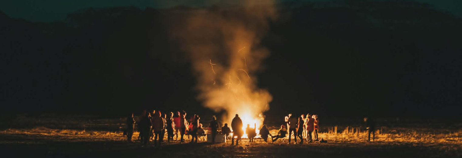 People around the fire at the festival.