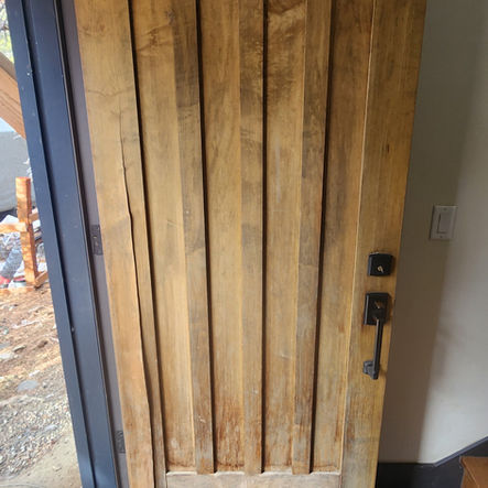 Wood door with vertical panels, installed by Bighorndesignbuild