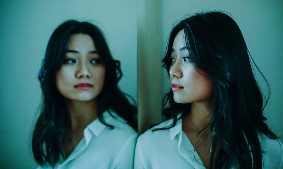Asian woman looking in the mirror
