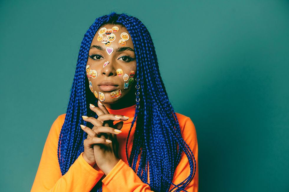woman with blue hair and happy emoji stickers on her face