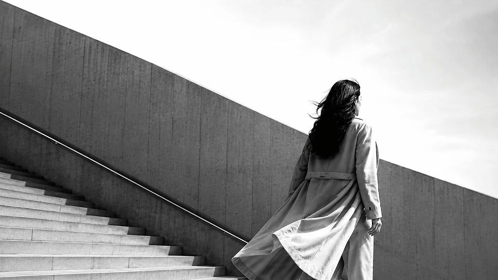 woman standing by a staircase