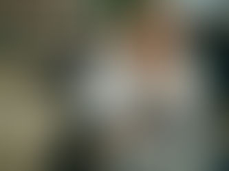 woman talking on the phone while writing on her laptop