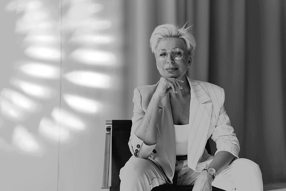 woman in a suit smiling confidently