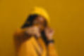 woman with yellow hat, yellow jacket and yellow glasses showing her fist wearing a BHER ring