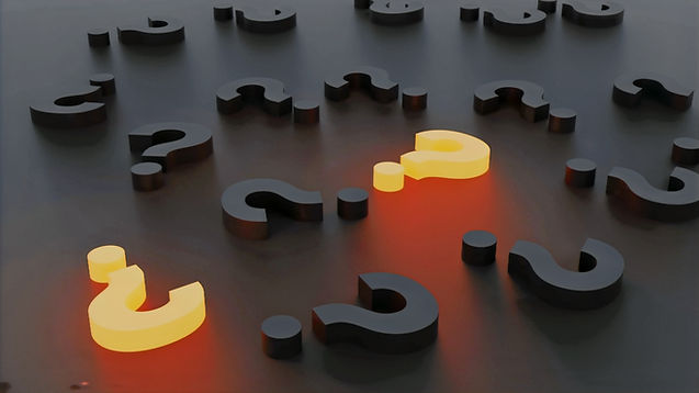 Yellowish-orange question marks against a dark background